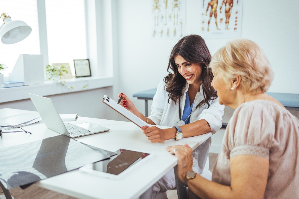 A female doctor reviews information with an elderly female patient. 