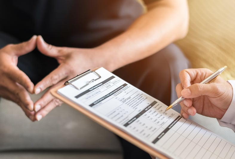 A doctor goes through a checklist with a patient. 