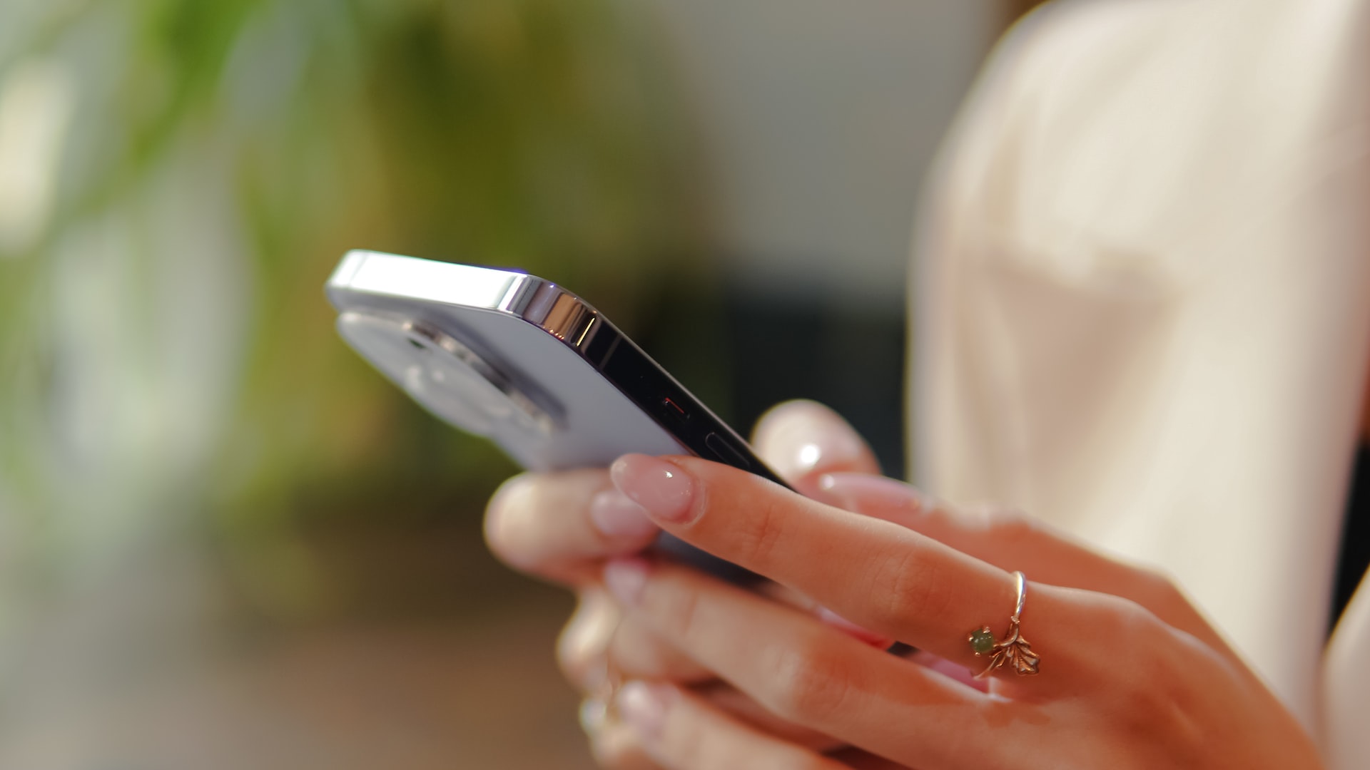 A woman holds a cell phone while using empathy-driven app Pyx Health. 